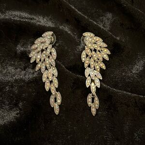 Pierced earrings. Rhinestone on silver toned backing.